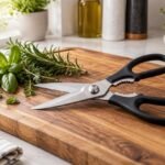 How to sharpen kitchen shears: stainless steel shears with fresh herbs on a cutting board